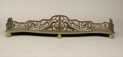 Appraisal: Victorian Pierced and Engraved Brass Fire Fender with Lion's Paw