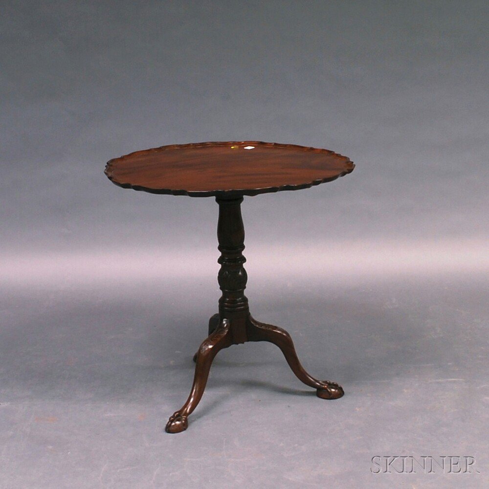 Appraisal: Chippendale-style Mahogany Piecrust Tilt-top Tea Table on a foliate-carved vasiform