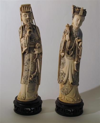 Appraisal: Two Chinese carved elephant ivory figuresTall male and female figures