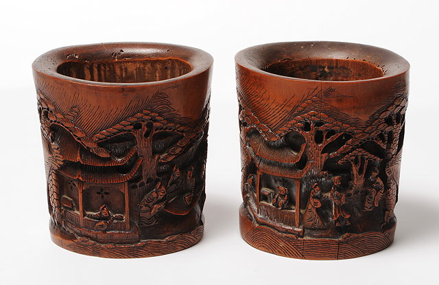 Appraisal: A PAIR OF CHINESE CARVED BAMBOO BRUSH POTS each decorated