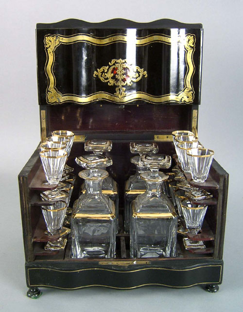 Appraisal: English ebonized cased liquor set th c the brass inlaid