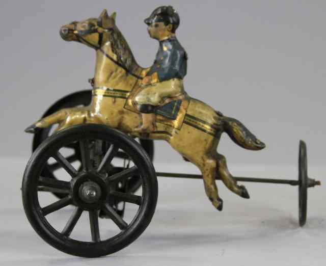 Appraisal: JOCKEY RIDING HORSE TOY Lithographed tin suited jockey atop white