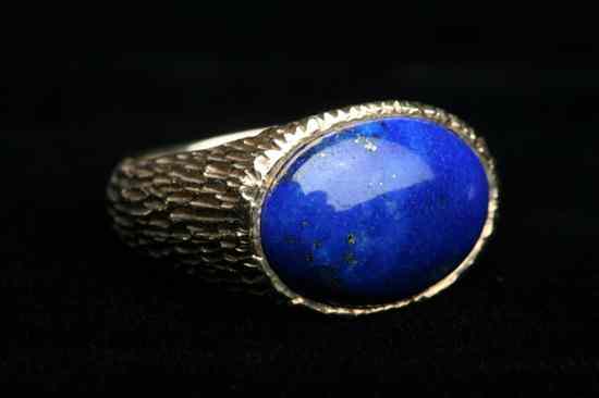 Appraisal: TEXTURED YELLOW GOLD AND LAPIS LAZULI OVAL CABOCHON DOME RING