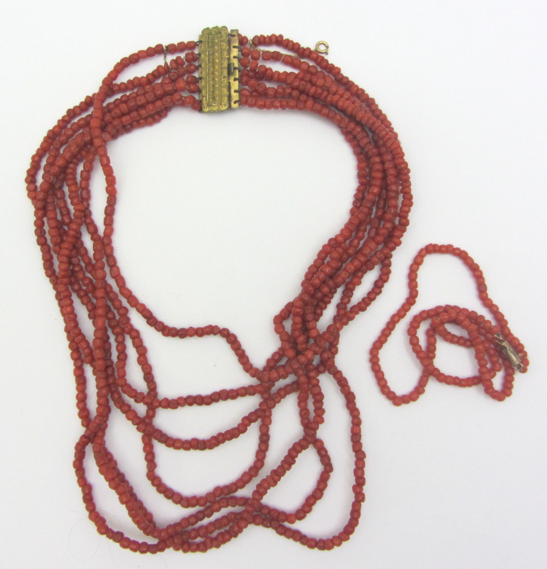 Appraisal: A seven row necklace of coral beads on a rectangular