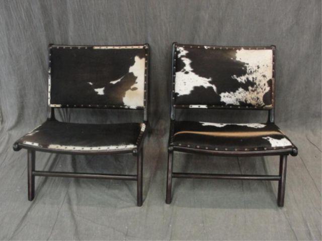 Appraisal: Pair of Cowhide Upholstered Chairs Lacquered wood and midcentury style