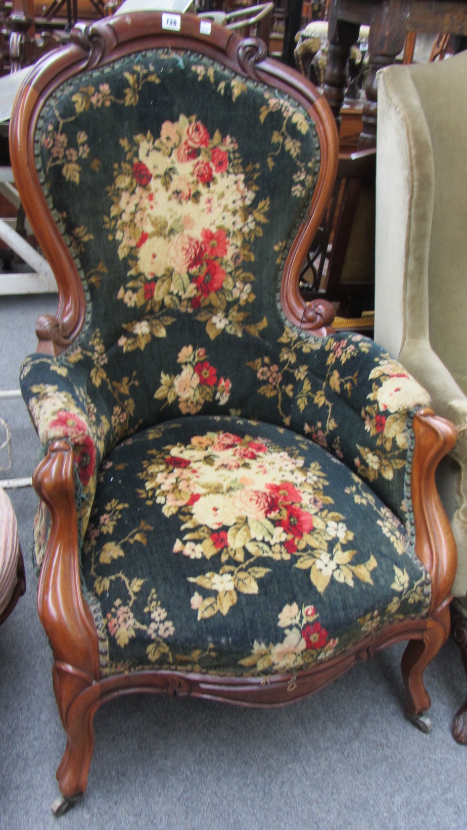 Appraisal: A Victorian mahogany spoonback armchair with serpentine seat and scroll