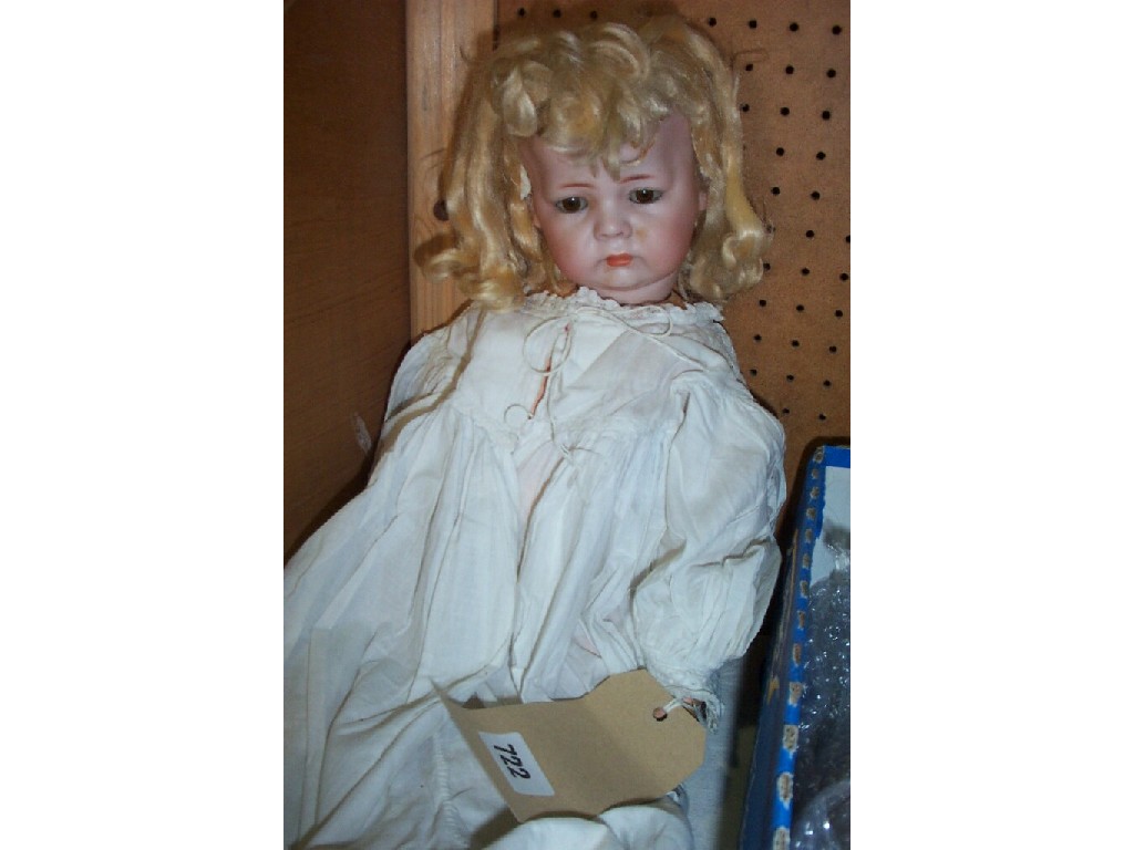 Appraisal: A bisque headed character doll with closing brown eyes and