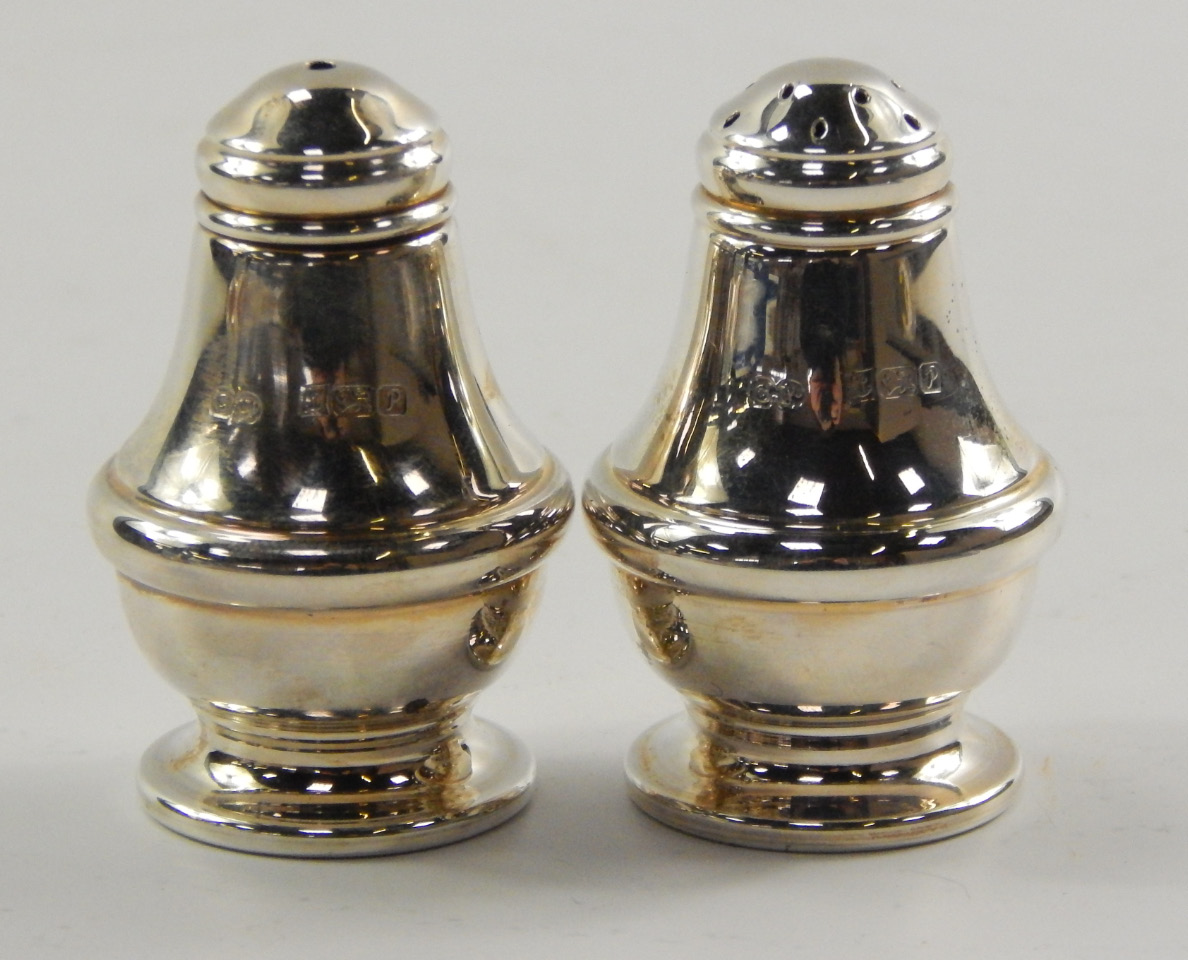 Appraisal: A silver salt and pepperette of baluster form Birmingham boxed