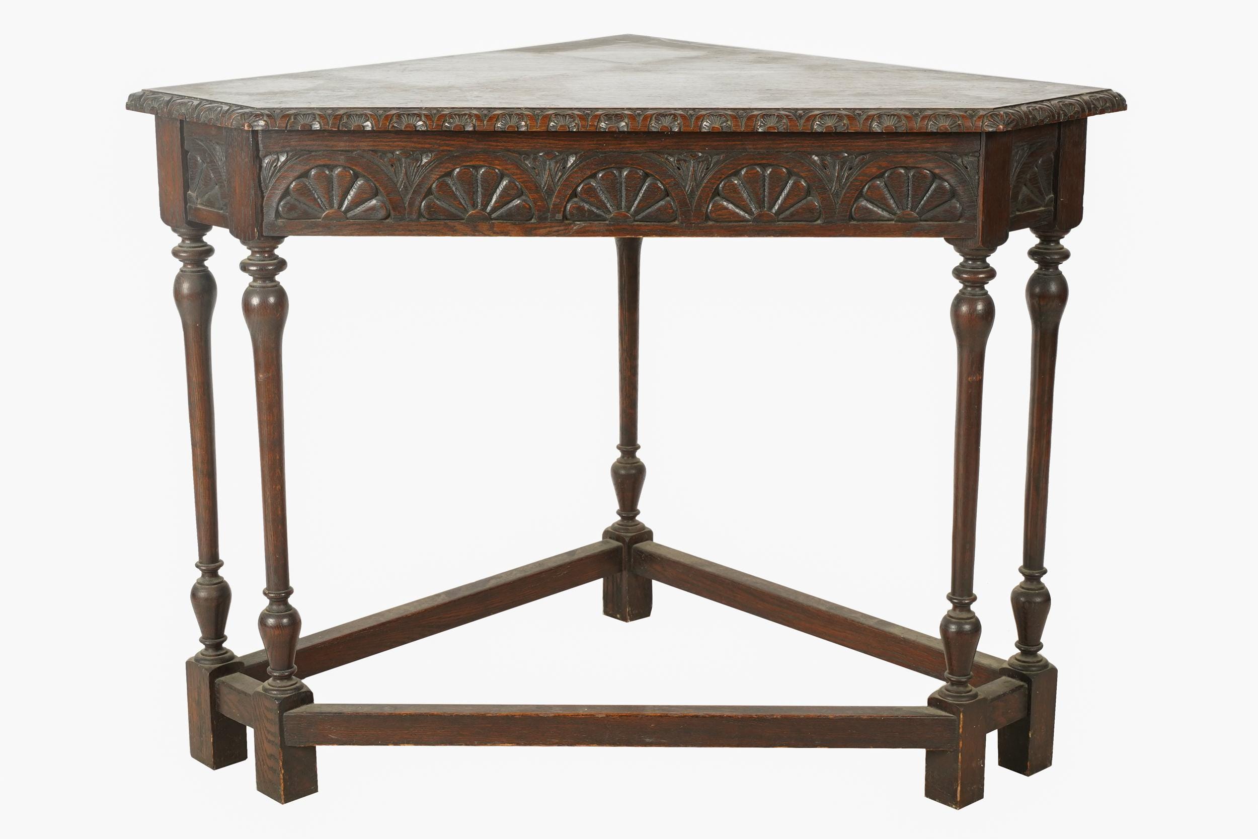 Appraisal: ENGLISH CARVED OAK CORNER TABLE the triangular top with canted