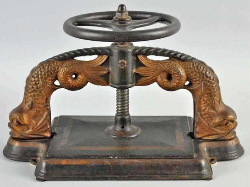 Appraisal: Cast Iron Book Press with Dolphins Description Numbered Condition Excellent