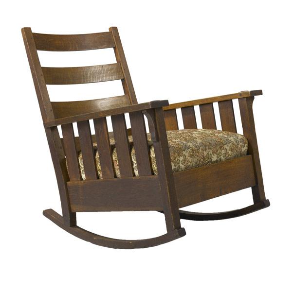 Appraisal: GUSTAV STICKLEY Rocking chair no with slatted arms and upholstered