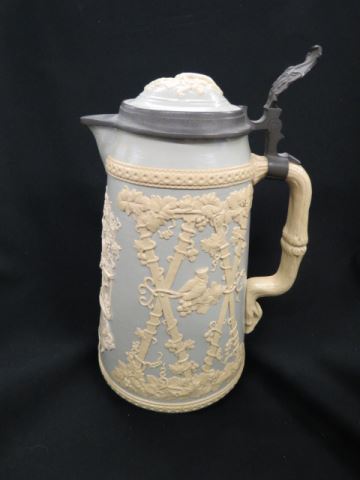 Appraisal: Mettlach Pottery Tankard Musician with guitar bas-relief scene inlaid pewter