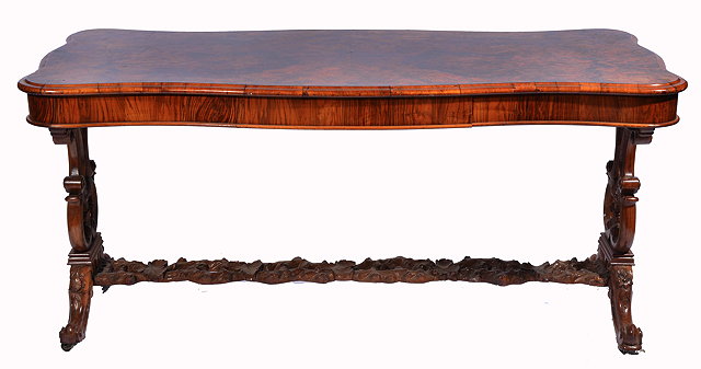 Appraisal: A VICTORIAN WALNUT CENTRE TABLE with a serpentine rectangular top