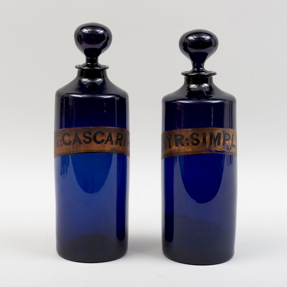 Appraisal: Pair of Victorian Cobalt Glass Apothecary Jars with Stoppers One