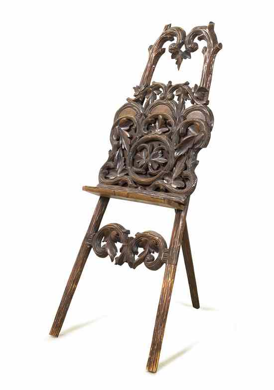 Appraisal: A Black Forest Style Carved Easel of typical frame form