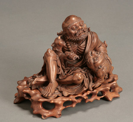 Appraisal: Japanese Hardwood Okimono of an Ascetic Sennin with Shishi Meiji