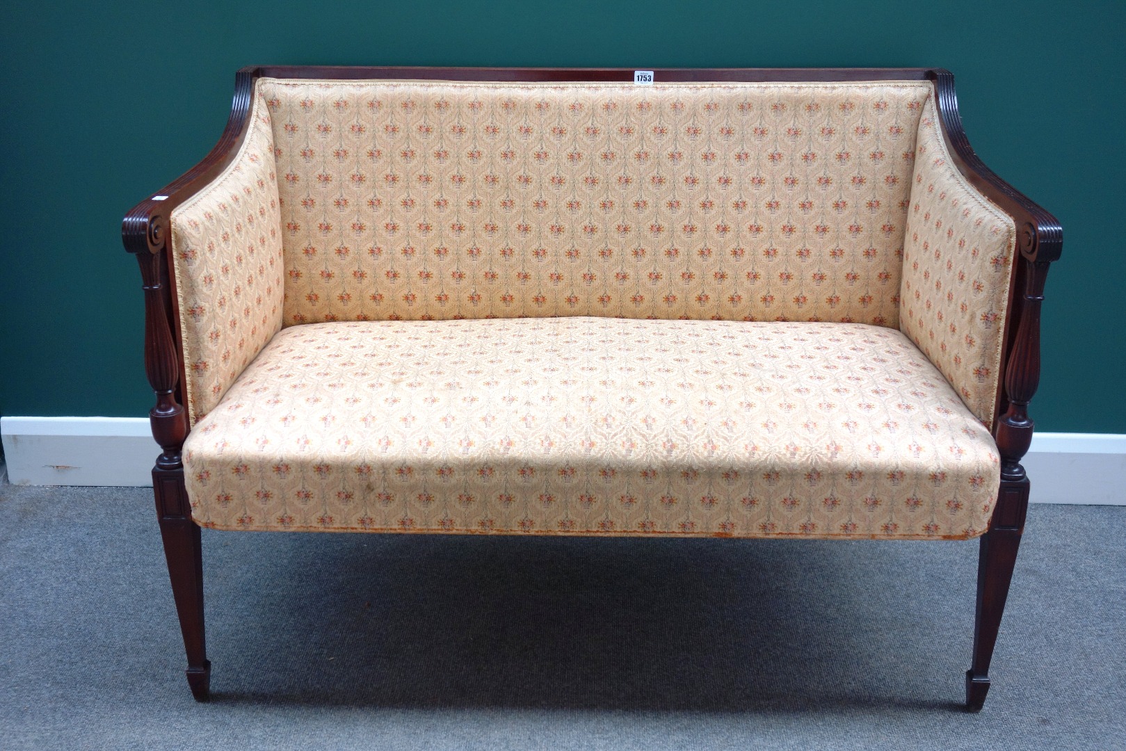 Appraisal: A small th century mahogany square back sofa with reeded