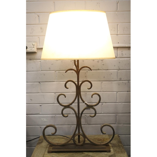 Appraisal: Scrolling wrought iron lamp with shade in working order at