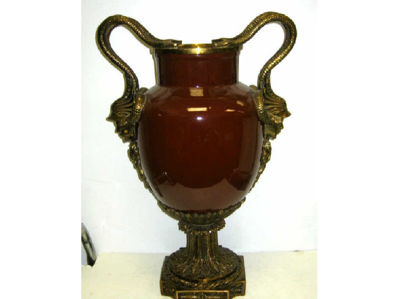 Appraisal: PAIR OF GILT METAL MOUNTED CERAMIC URNS Burgundy glazed ovoid