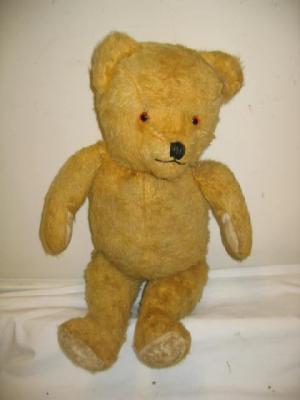 Appraisal: An English teddy bear straw filled covered in gold plush