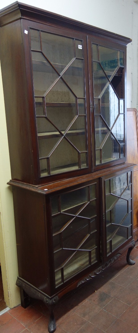 Appraisal: A th century mahogany double height glazed display cabinet with