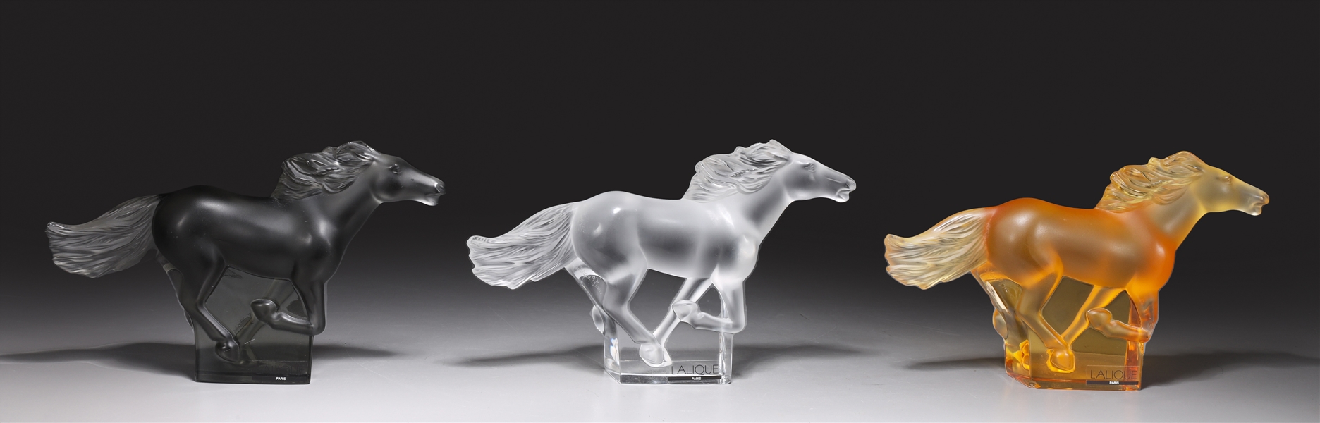 Appraisal: Group of three Lalique horse figurines of different colors honey