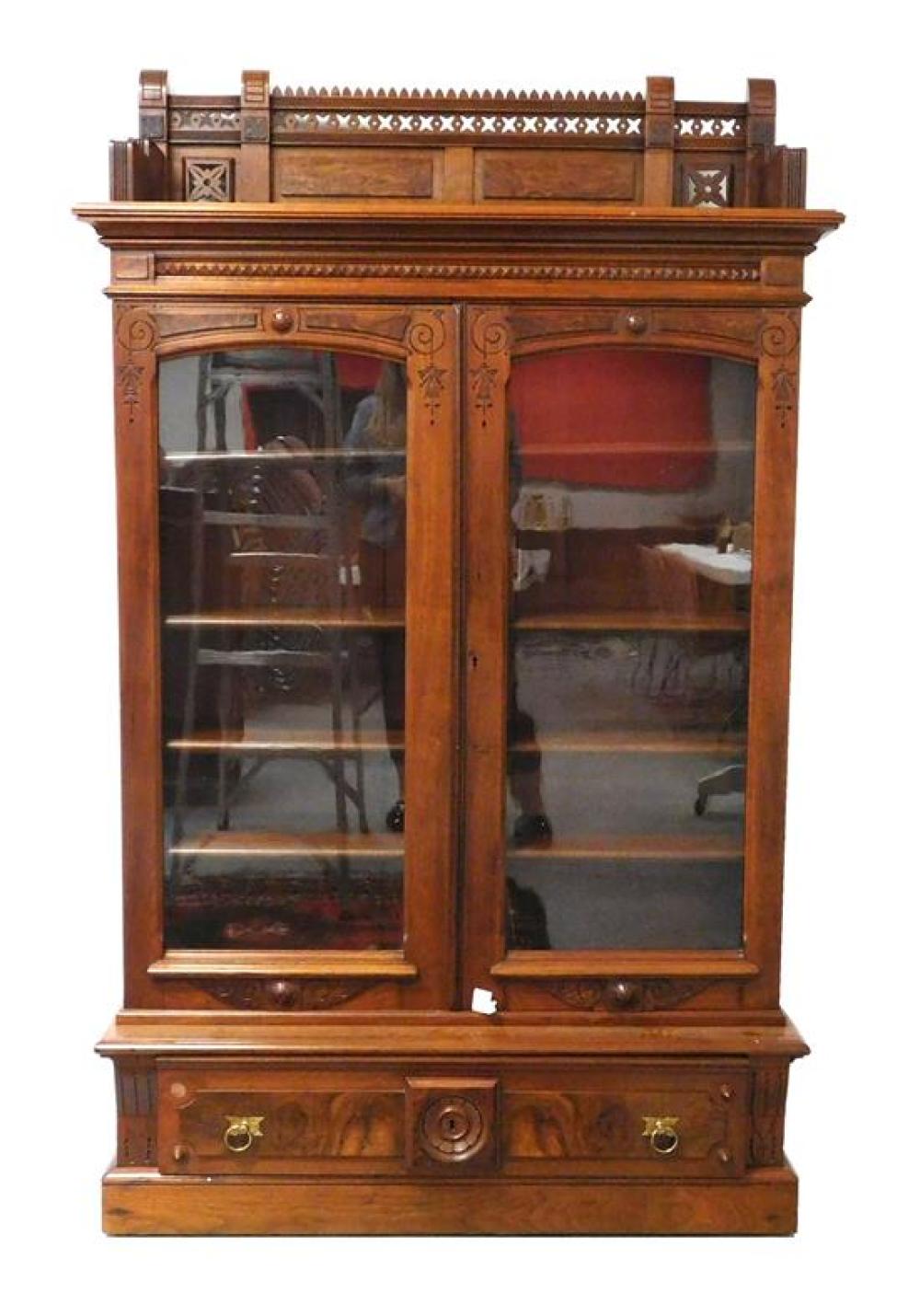 Appraisal: Eastlake bookcase with ornately carved and pierced gallery top over