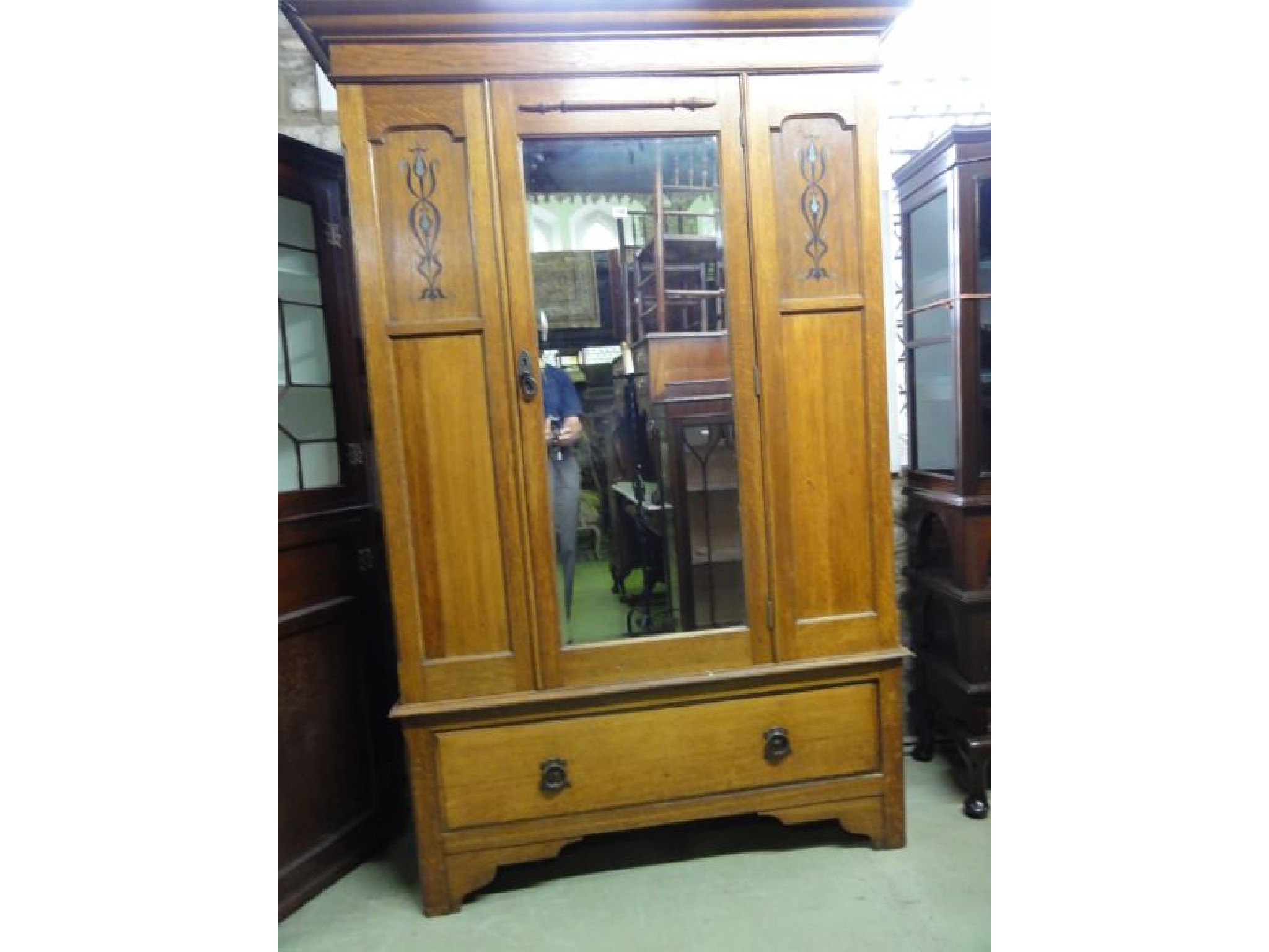 Appraisal: An Edwardian Arts Crafts style oak wardrobe the moulded cornice