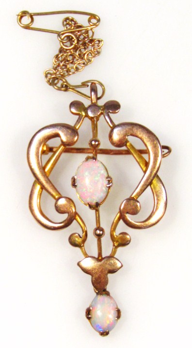 Appraisal: An Edwardian drop pendant claw set with two opals in