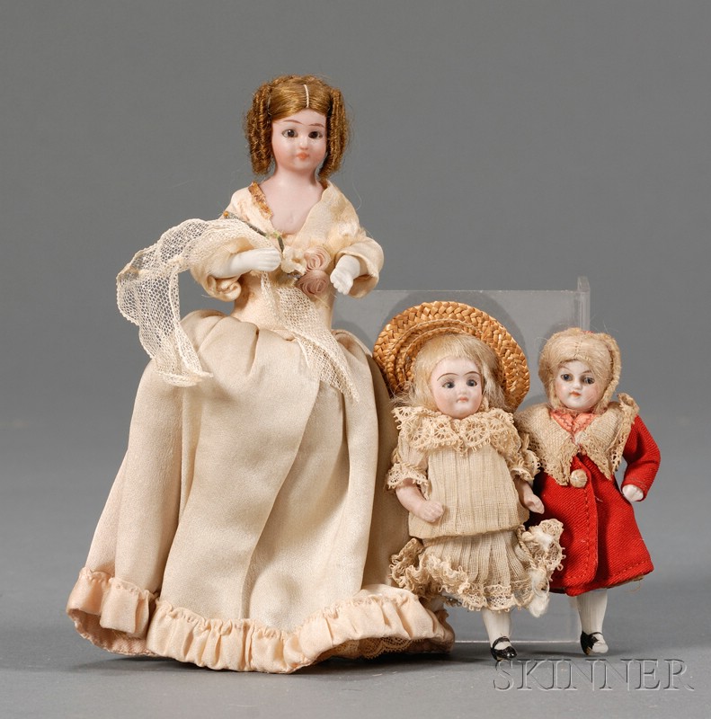 Appraisal: Three Small Bisque Dollhouse Dolls with Glass Eyes late th