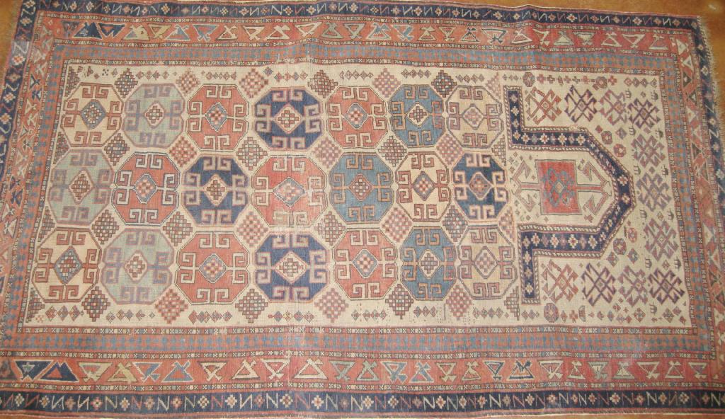 Appraisal: A multi bordered Prayer Rug geometric design on beige ground