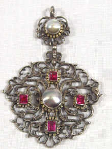 Appraisal: An antique silver pendant set with red paste stones