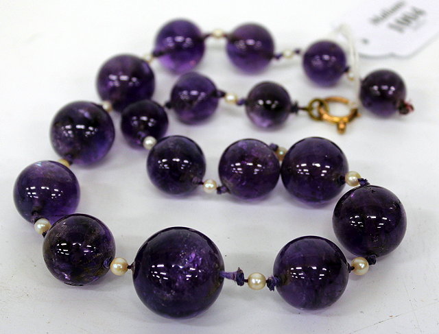 Appraisal: A NECKLACE OF GRADUATED AMETHYST BEADS interspersed with pearls cm