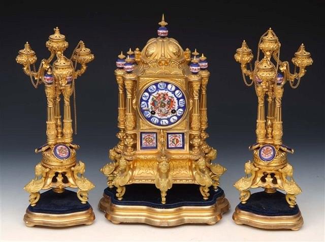 Appraisal: A FRENCH ORMOLU AND PORCELAIN MOUNTED GARNITURE DU CHEMIN E