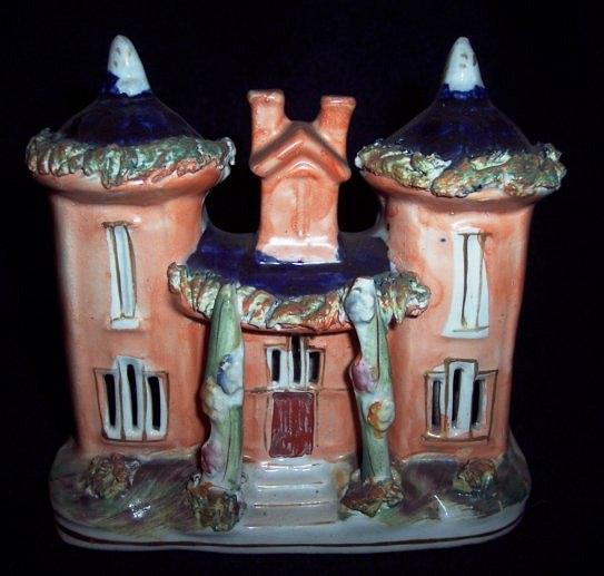 Appraisal: A Staffordshire pastille burner a cottage with two towers and