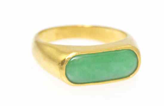 Appraisal: A Yellow Gold and Jadeite Saddle Ring having an apple