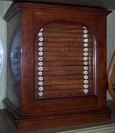 Appraisal: A Victorian mahogany coin cabinet with arch glass panelled door