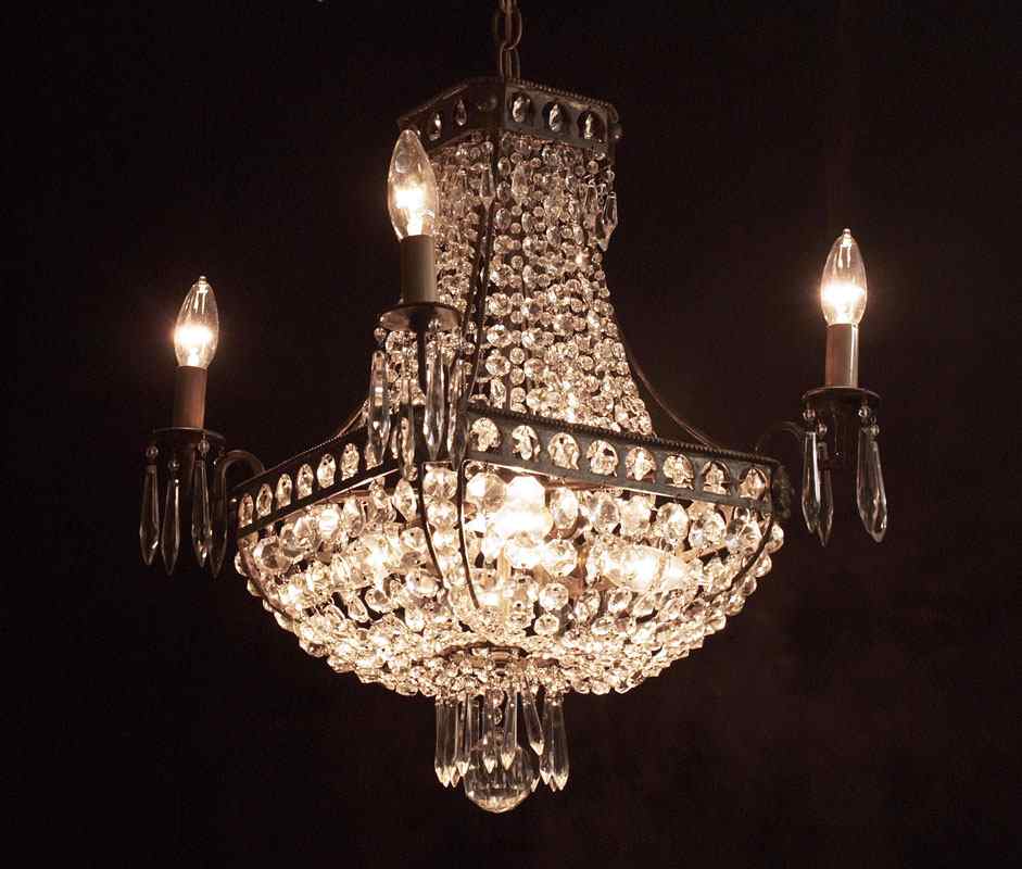 Appraisal: DIMINUTIVE FRENCH EMPIRE STYLE CRYSTAL CHANDELIER lights under the crystals