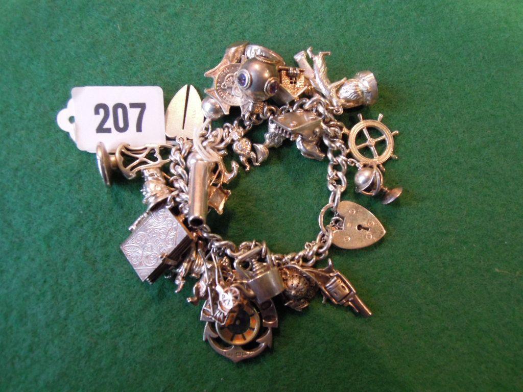 Appraisal: A heavy silver charm bracelet hung with about thirty charms