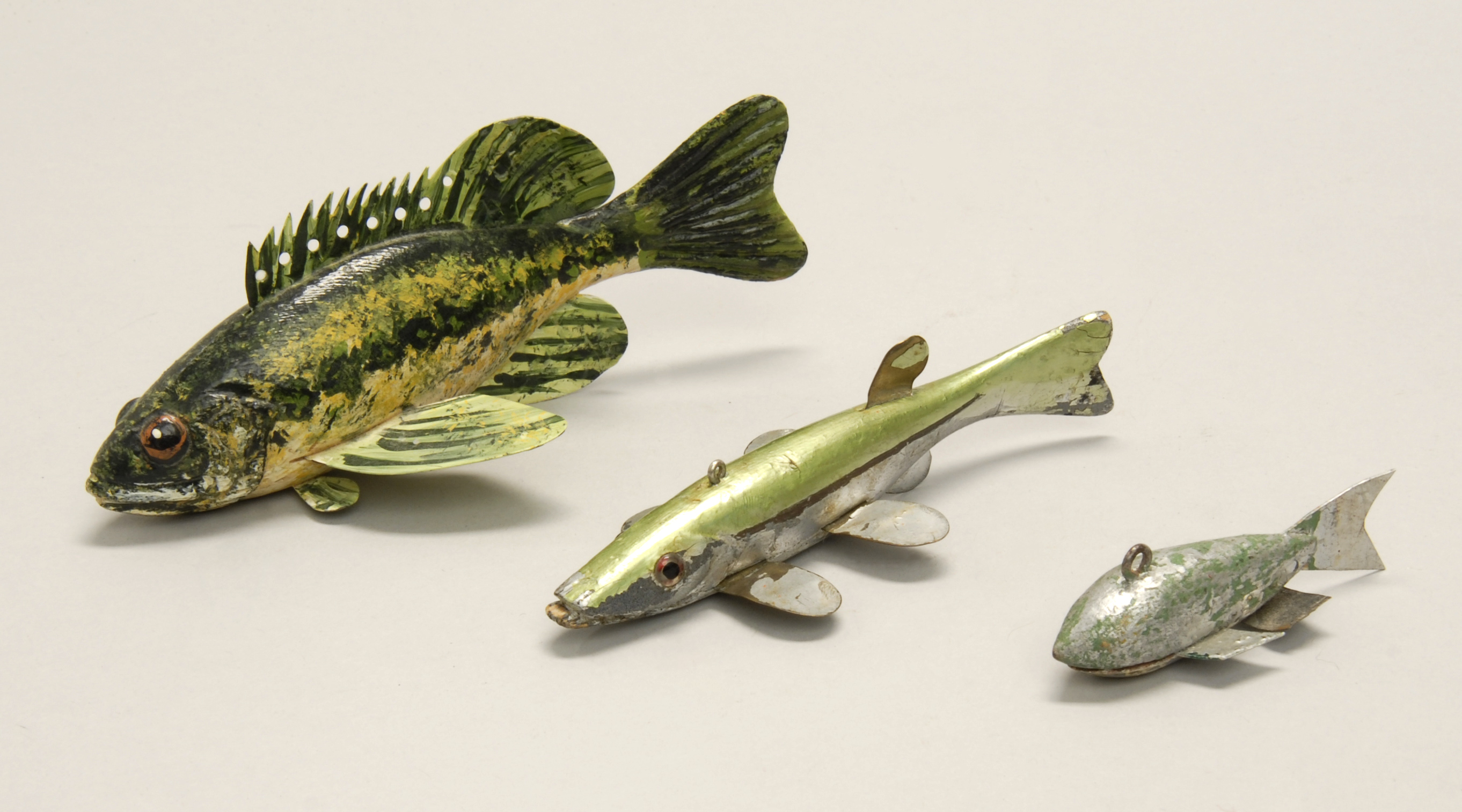 Appraisal: THREE WOODEN FISH DECOYS th CenturyTwo with glass eyes Lengths