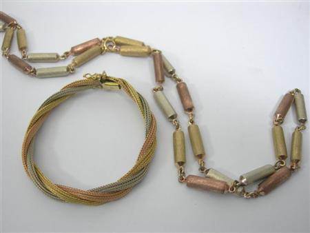 Appraisal: A three-colour gold bracelet of interwoven scroll design stamped also