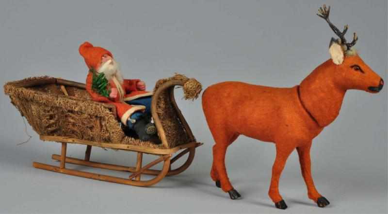 Appraisal: Santa-Driven Moss-Covered Sleigh Candy Container Description German Reindeer candy container