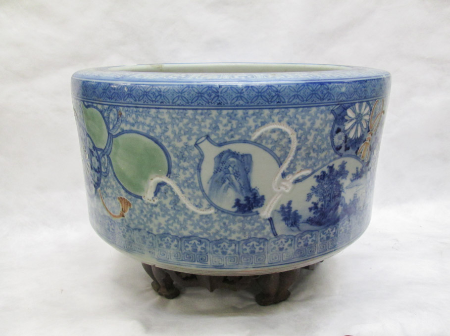 Appraisal: ROUND CHINESE PORCELAIN PLANTER ON WOOD STAND the sides with