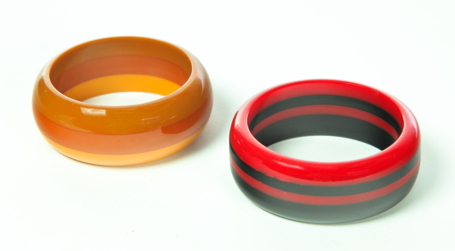 Appraisal: TWO LAMINATE BAKELITE BRACELETS American st half- th century Red