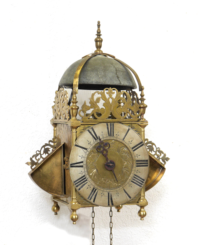 Appraisal: AN ENGLISH BRASS WINGED LANTERN CLOCK SIGNED SAMUEL COCKS OF