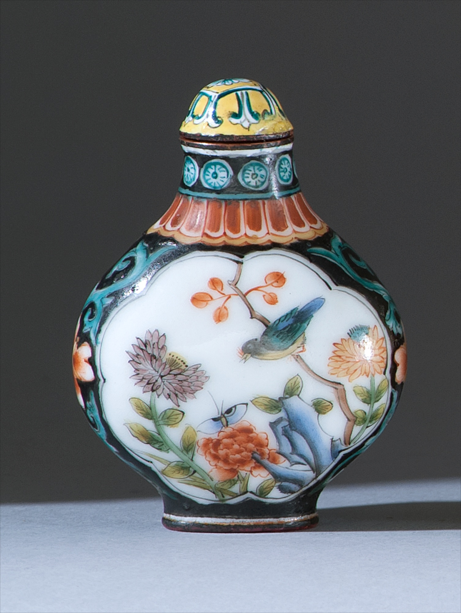 Appraisal: BEIJING ENAMEL SNUFF BOTTLE In flattened ovoid form with bird