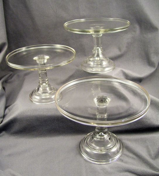 Appraisal: - Clear Glass Pedestal Stands One measures high and diameter