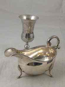 Appraisal: A silver sauce boat cm long London and a silver