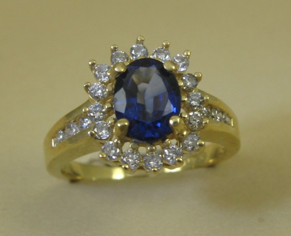 Appraisal: SAPPHIRE AND FOURTEEN KARAT GOLD RING centering an oval-cut blue