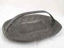 Appraisal: A Tudric pewter dish with handle decorated with squared honesty